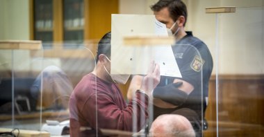 Syrian defendant Eyad al-Gharib hides his face as he arrives to hear his verdict in a courtroom in Koblenz, Germany, Feb. 24, 2021. (AP Photo)