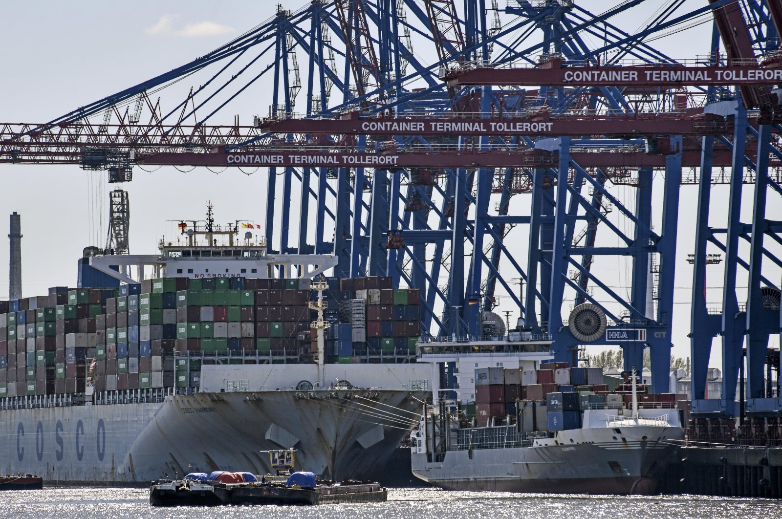 Port cranes load container ships at the import and export harbor in Hamburg, Germany, March 19, 2022. (AP Photo)
