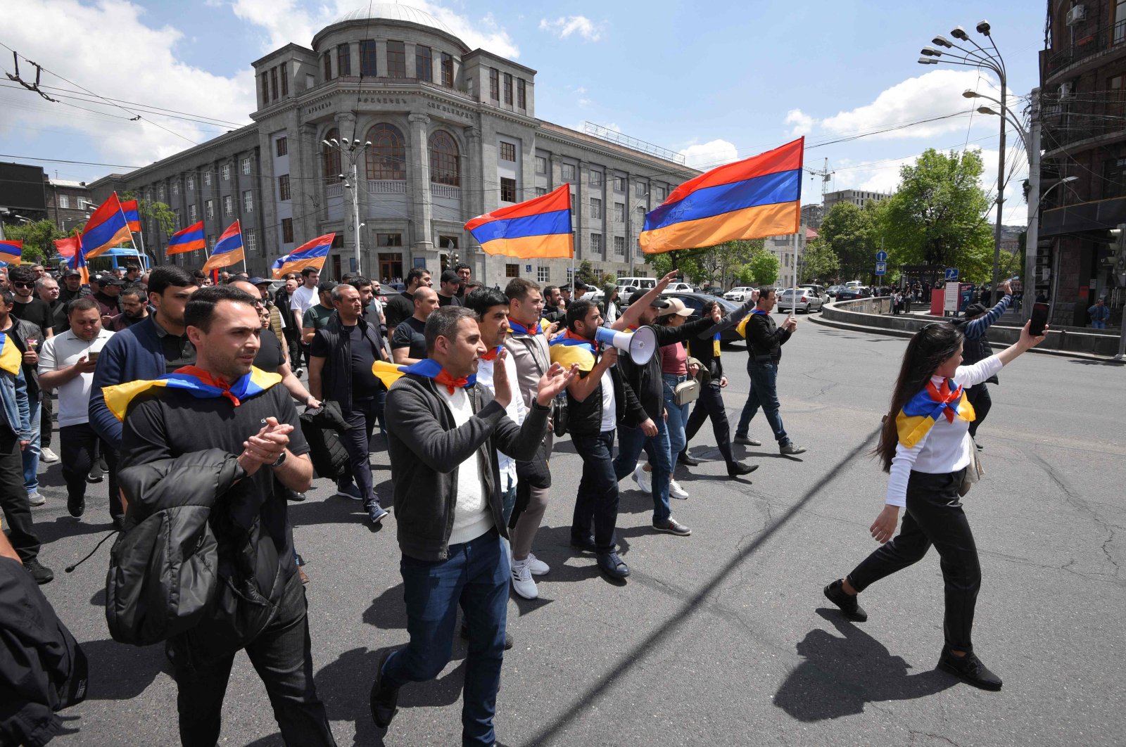 Demonstrators shout slogans and hold Armenian flags as they take part in an opposition rally to protest against the Karabakh concession in Yerevan on May 4, 2022. (AFP)