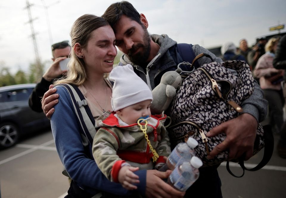 A family of Ukrainian evacuees from Mariupol embraces after arriving at a registration center for internally displaced people, Zaporizhzhia, Ukraine, May 3, 2022. (Reuters Photo)