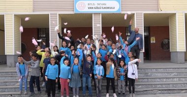 Students at a school throw COVID-19 masks into the air after the end of the mask mandate, in Bitlis, eastern Turkey, April 28, 2022. (IHA PHOTO)