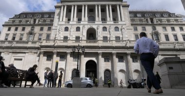 People walk past the Bank of England in London, U.K., May 5, 2022. (AP Photo)
