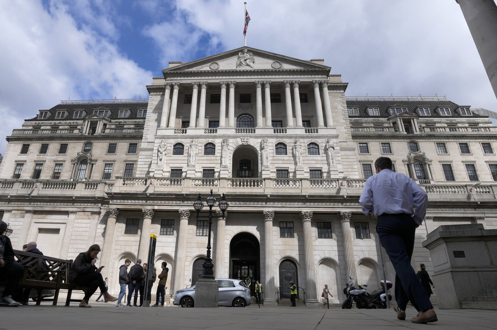 People walk past the Bank of England in London, U.K., May 5, 2022. (AP Photo)