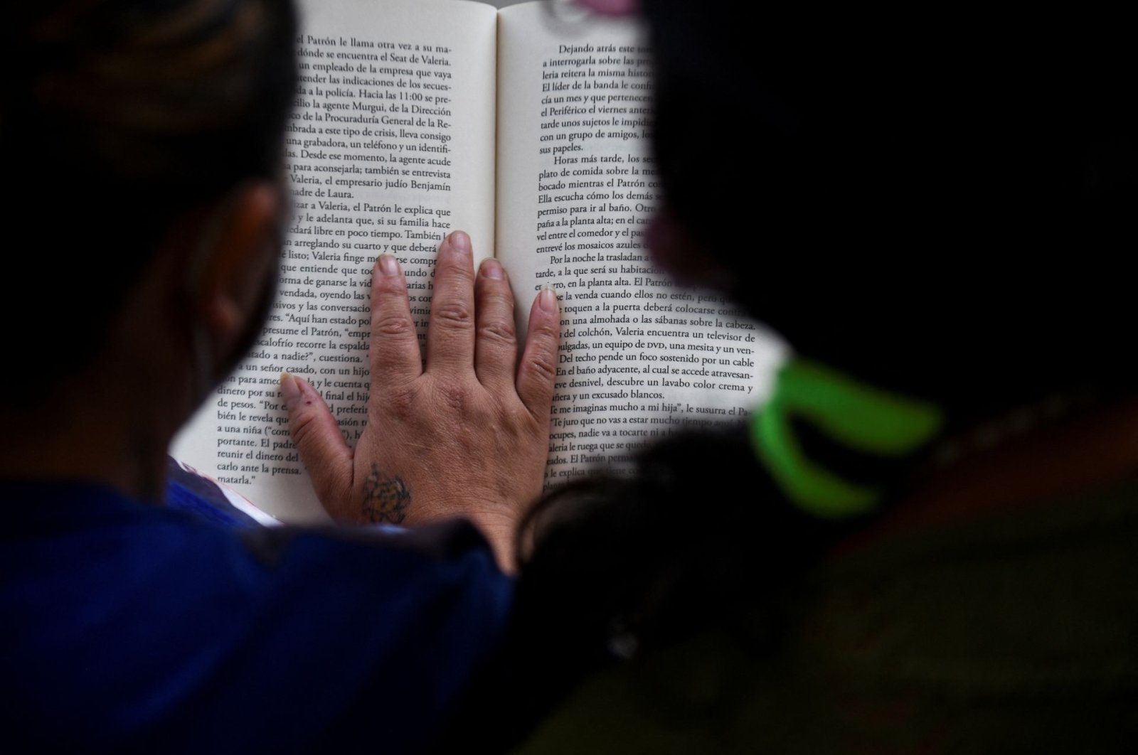 Jaqueline and a fellow inmate read a book in prison where they have access to a small library as part of a program that aims to spread literacy and offer the chance to get out of jail earlier, in La Paz, Bolivia, April 29, 2022. (Reuters Photo)