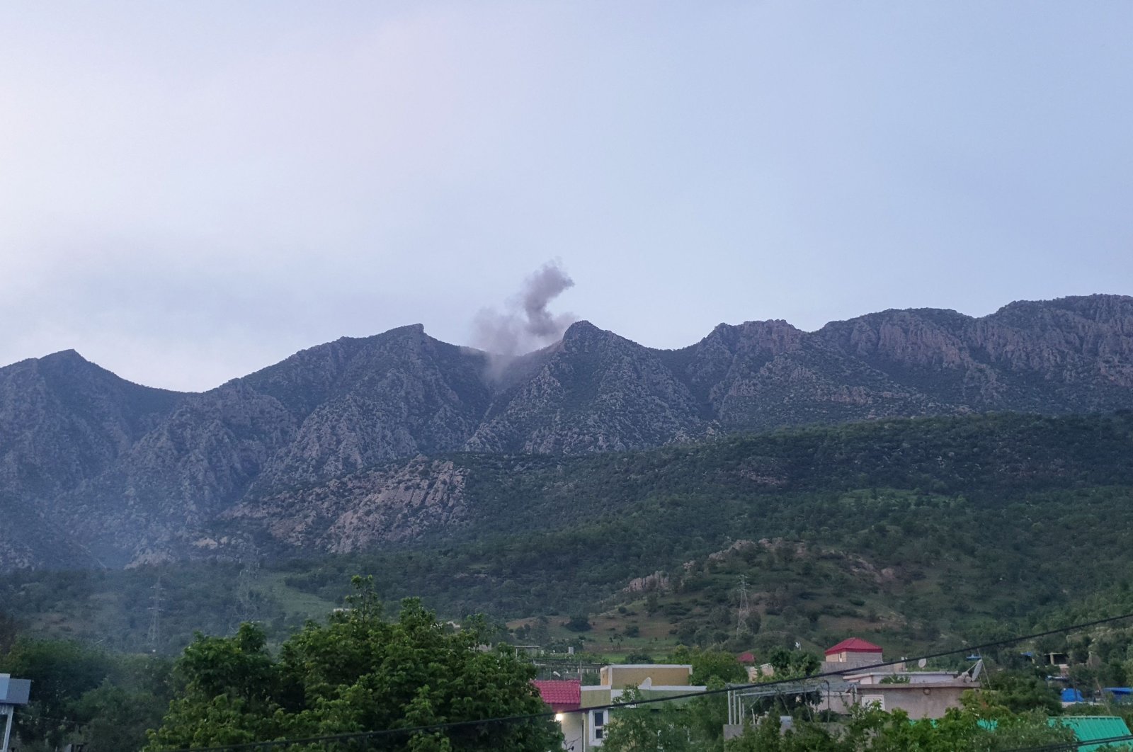 Smoke billows following reported Turkish warplane raids against PKK terrorists, from a site in the Matin Mountains near the village of Koherzi in the Amadiyah district, northeast of Dohuk in northern Iraq, on April 28th 2022. (AFP)