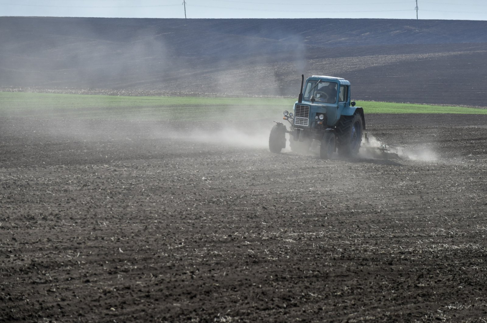A farmer drives a tractor on a field in the Khmelnytsky region, Ukraine, May 2, 2022. (EPA Photo)