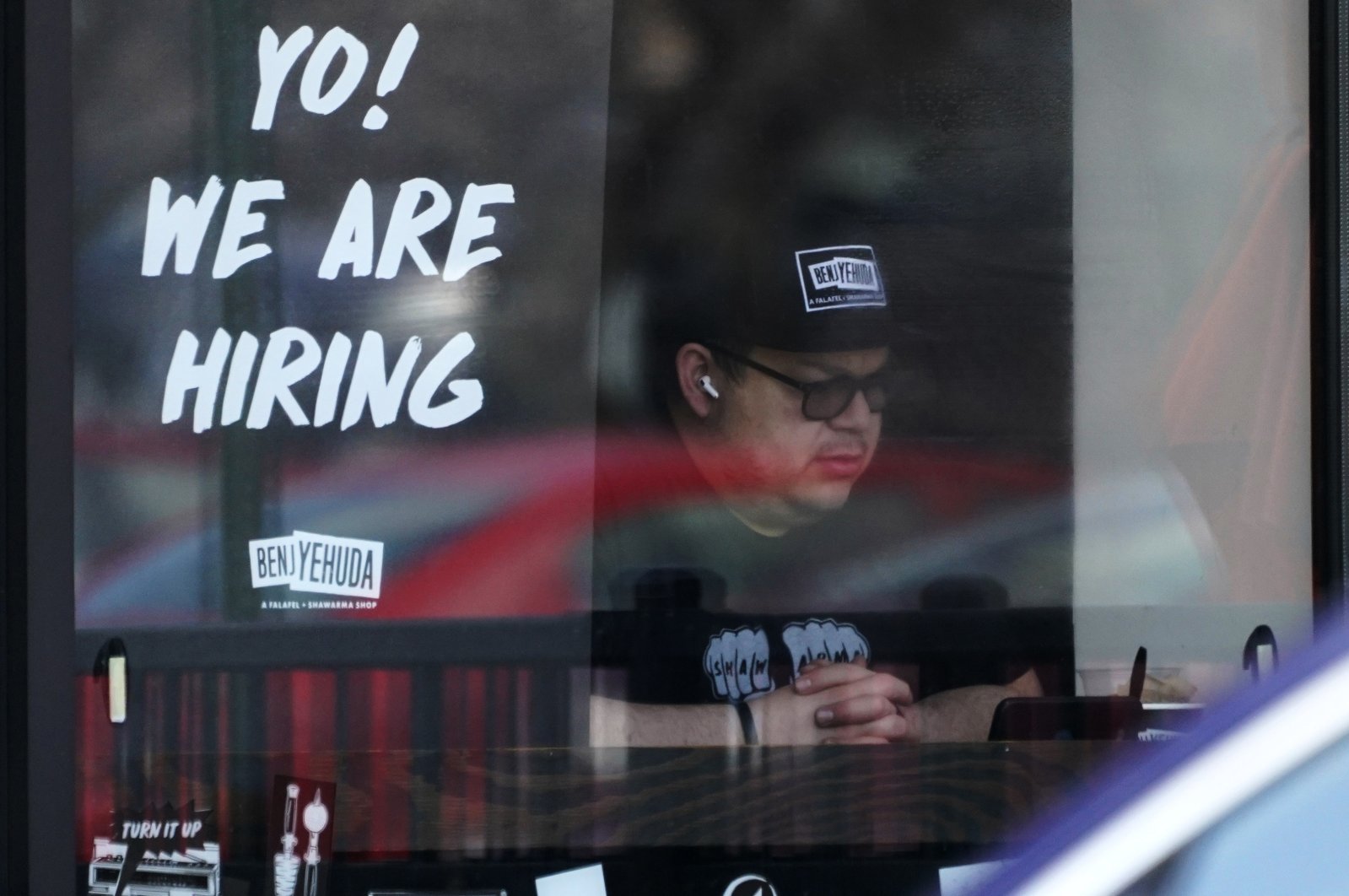 A hiring sign is displayed at a restaurant in Schaumburg, Illinois, U.S., April 1, 2022. (AP Photo)