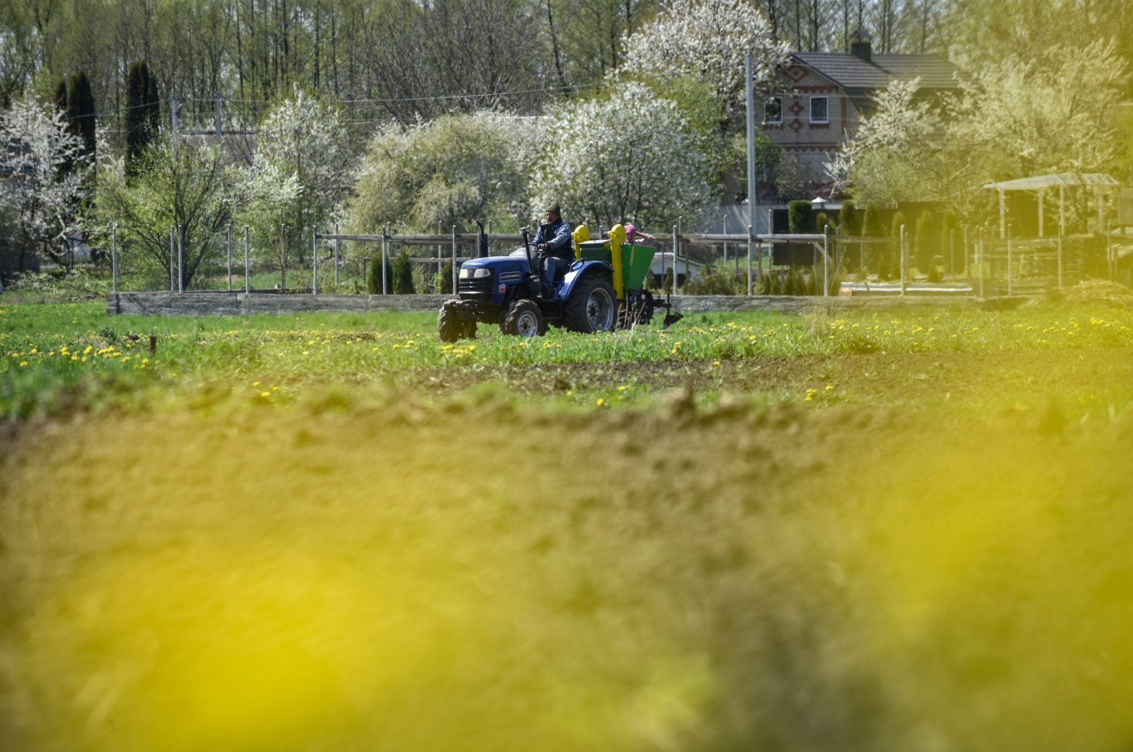 A farmer drives a tractor on the field in Vinnytsia region, Ukraine, May 2, 2022. (EPA Photo)