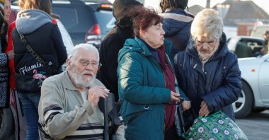 Civilians gather near buses carrying people evacuated from Mariupol in the course of Ukraine-Russia conflict, in the village of Bezimenne in the Donetsk region, Ukraine, May 7, 2022. (Reuters Photo)