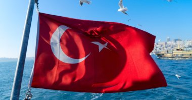 The Turkish flag hangs in the air on a Bosporus ferry, Istanbul, Turkey, April 28, 2022. (Photo by Shutterstock)