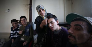 Sahile Gümüş cares for her disabled children in Aydın, western Turkey, May 7, 2022. (AA PHOTO)