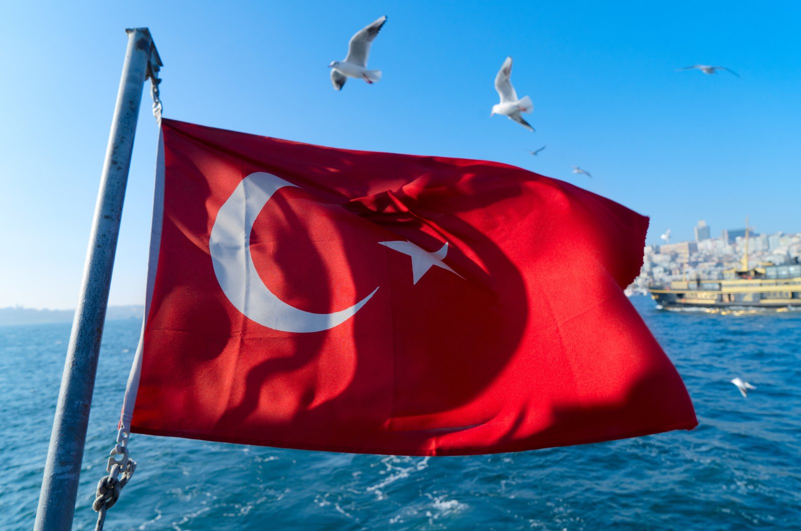 The Turkish flag hangs in the air on a Bosporus ferry, Istanbul, Turkey, April 28, 2022. (Photo by Shutterstock)