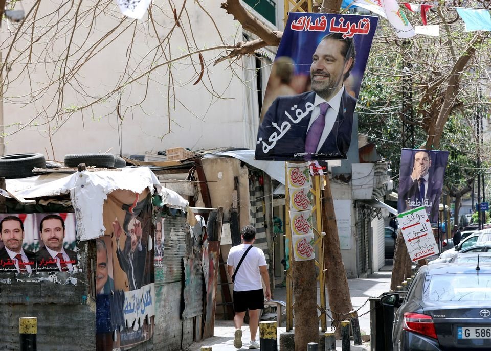 A man walks past posters depicting Lebanon&#039;s former Prime Minister Saad Hariri in this undated photo, Beirut, Lebanon. (Reuters Photo)