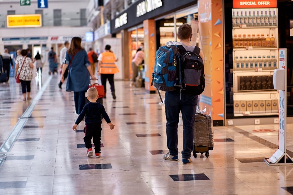 A father and son walk in the airport, Antalya, Turkey, May 19, 2021. (Shutterstock Photo)