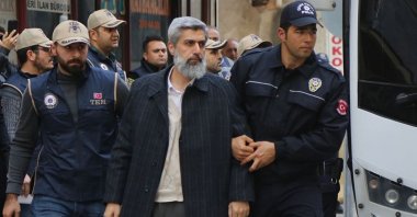 Police escort Alparslan Kuytul after his arrest, in Adana, southern Turkey, Feb. 8, 2018. (AA PHOTO) 