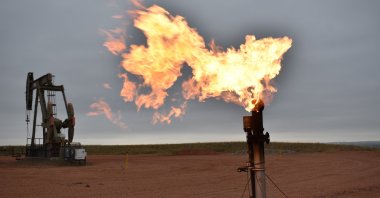 A flare burns natural gas at an oil well in Watford City, North Dakota, U.S., Aug. 26, 2021. (AP File Photo)