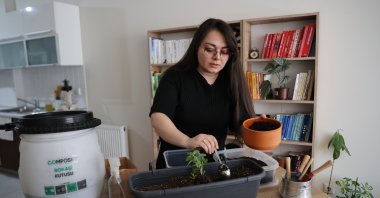 Hiba Sinem Demirkan shows the compost mechanism and the compost she extracted at her home, in Istanbul, Turkey, May 9, 2022. (AA Photo)