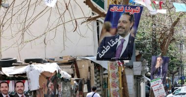 A man walks past posters depicting Lebanon&#039;s former Prime Minister Saad Hariri in this undated photo, Beirut, Lebanon. (Reuters Photo)