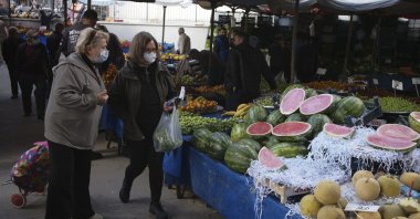 People buy local products at an open air food market, in Ankara, Turkey, May 8, 2022. (AP Photo)