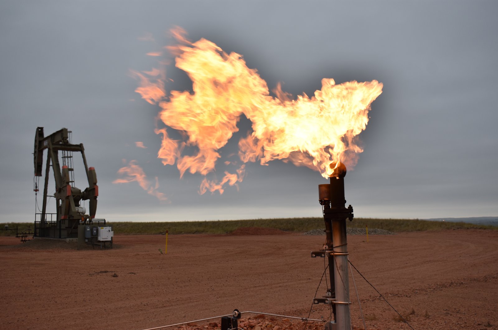 A flare burns natural gas at an oil well in Watford City, North Dakota, U.S., Aug. 26, 2021. (AP File Photo)