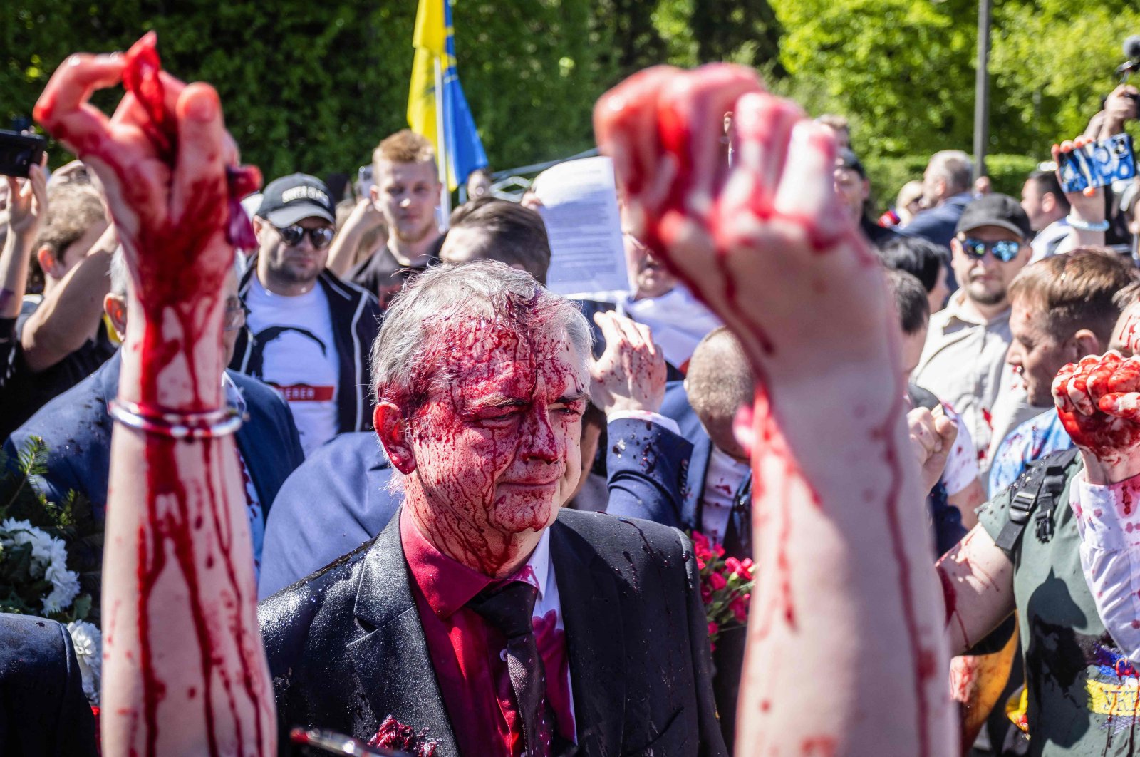 Russian Ambassador to Poland, Ambassador Sergey Andreev reacts after being covered with red paint during a rally for peace in Ukraine in Warsaw, Poland, May 9, 2022. (AFP Photo)