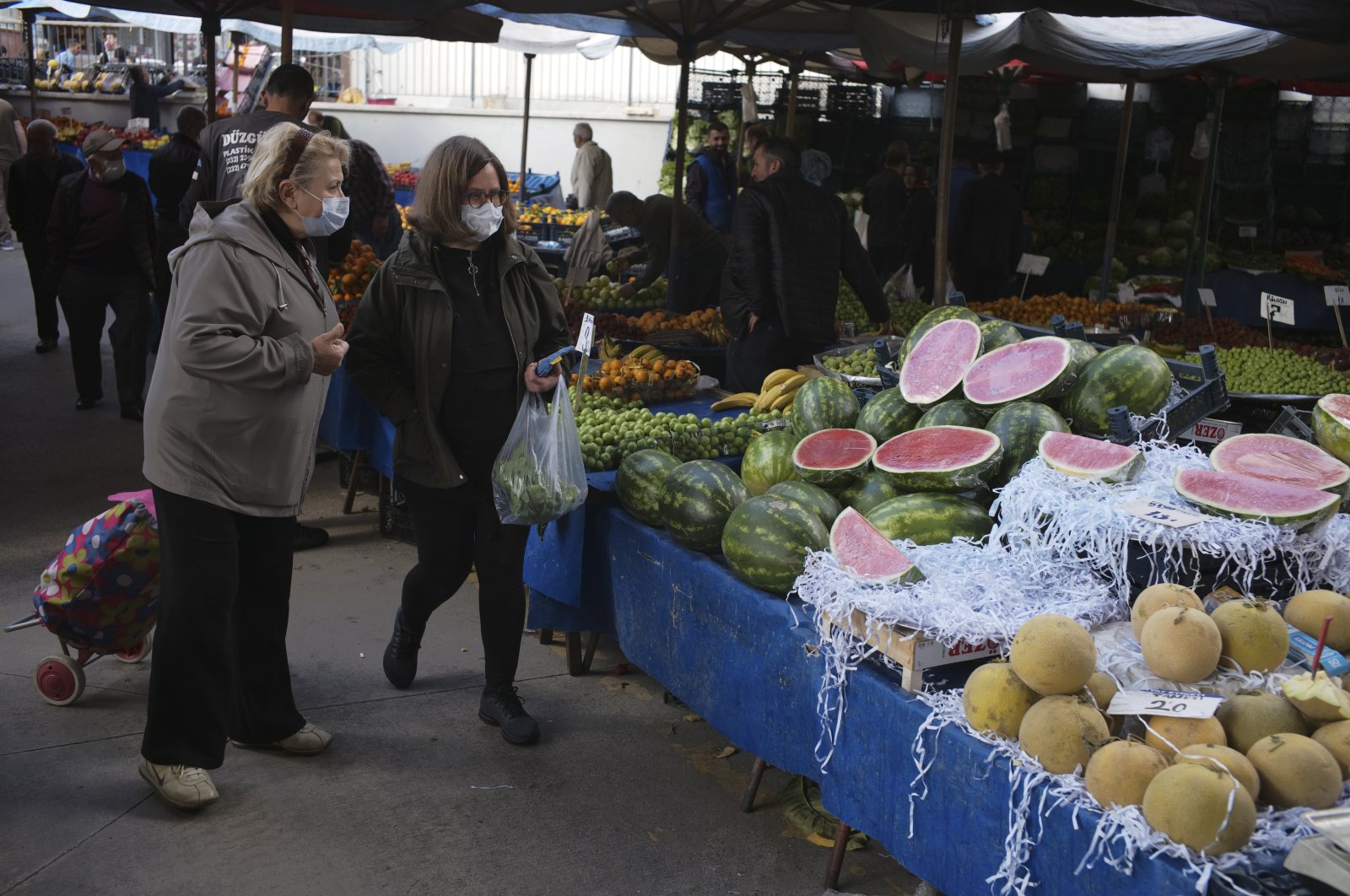 People buy local products at an open air food market, in Ankara, Turkey, May 8, 2022. (AP Photo)