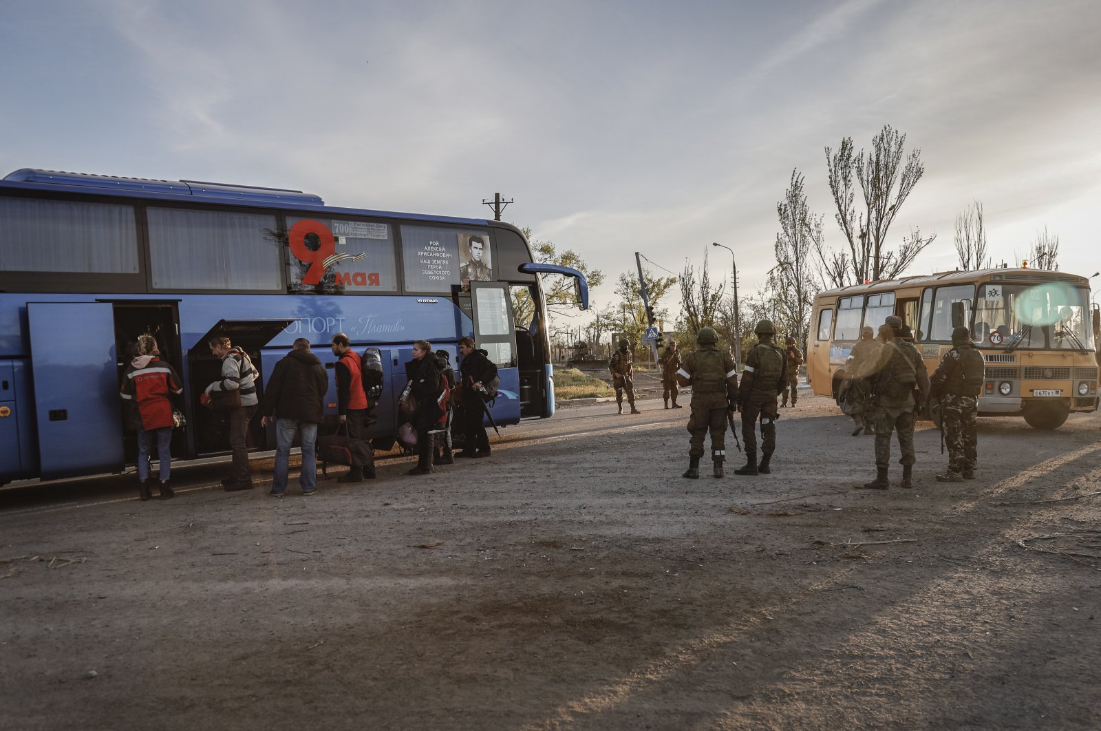 Russian servicemen control the boarding of a bus by the civilians, who were evacuated from Azovstal in Mariupol, Ukraine, May 6, 2022. (EPA Photo)