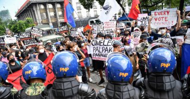 People display placards during a rally in front of the commission on elections to protest against the results of the presidential election, Manila, the Philippines, May 10, 2022. (AFP Photo)