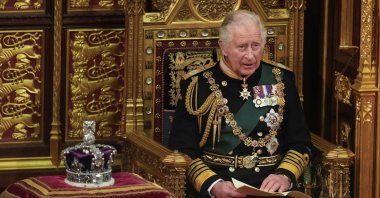 Prince Charles reads the queen's speech seated next to her crown during the State Opening of Parliament, at the Palace of Westminster in London, Britain, May 10, 2022. (AP Photo)