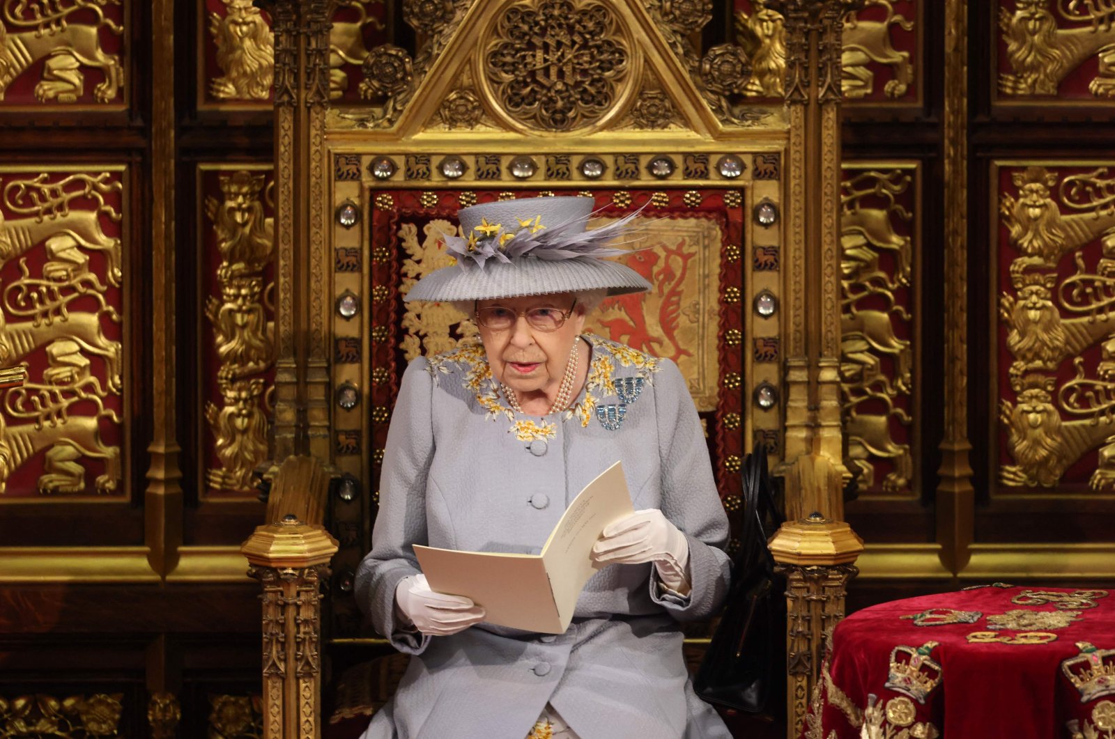 Queen Elizabeth II reads the Queen&#039;s speech on her throne in the House of Lords during the opening of Parliament at the Houses of Parliament, London, U.K., May 11, 2021. (AFP Photo)