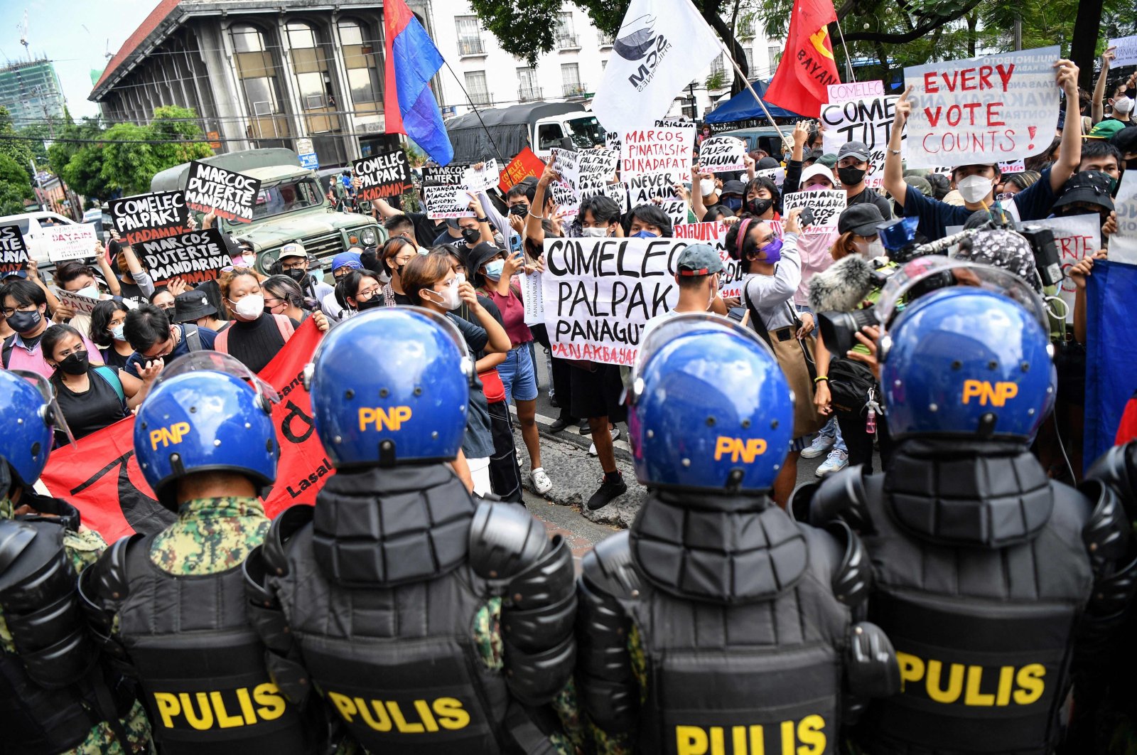 People display placards during a rally in front of the commission on elections to protest against the results of the presidential election, Manila, the Philippines, May 10, 2022. (AFP Photo)