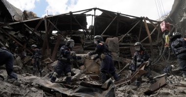 Emergency personnel clear debris in a partially destroyed drama theater in the city of Mariupol, Ukraine, May 10, 2022. (AFP Photo)