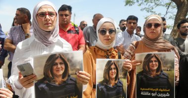 Palestinians hold pictures of Al-Jazeera reporter Shireen Abu Akleh, who was killed by Israeli army gunfire during an Israeli raid, in the occupied West Bank, Palestine, May 11, 2022. (Reuters Photo)