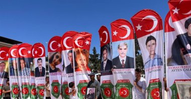 People hold pictures of victims during the remembrance events, in Reyhanlı, in Hatay, southern Turkey, May 11, 2022. (İHA PHOTO)