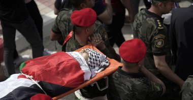 Slain Al-Jazeera veteran journalist Shireen Abu Akleh is carried by a Palestinian honor guard in the city of Nablus, the West Bank, Palestine, Wednesday, May 11, 2022. She was shot and killed while covering an Israeli raid in the occupied West Bank town of Jenin early Wednesday. (AP Photo/Majdi Mohammed)