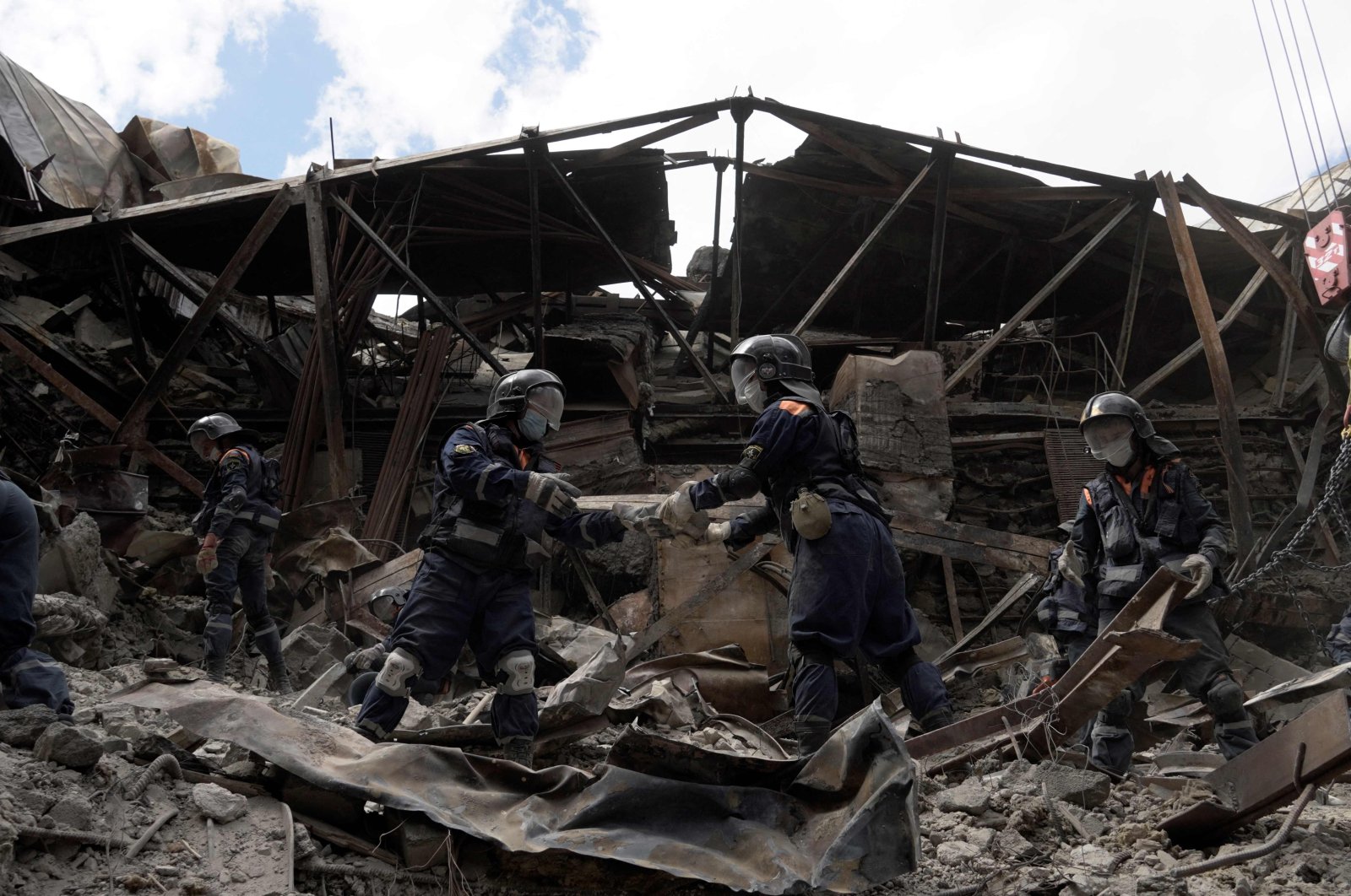 Emergency personnel clear debris in a partially destroyed drama theater in the city of Mariupol, Ukraine, May 10, 2022. (AFP Photo)