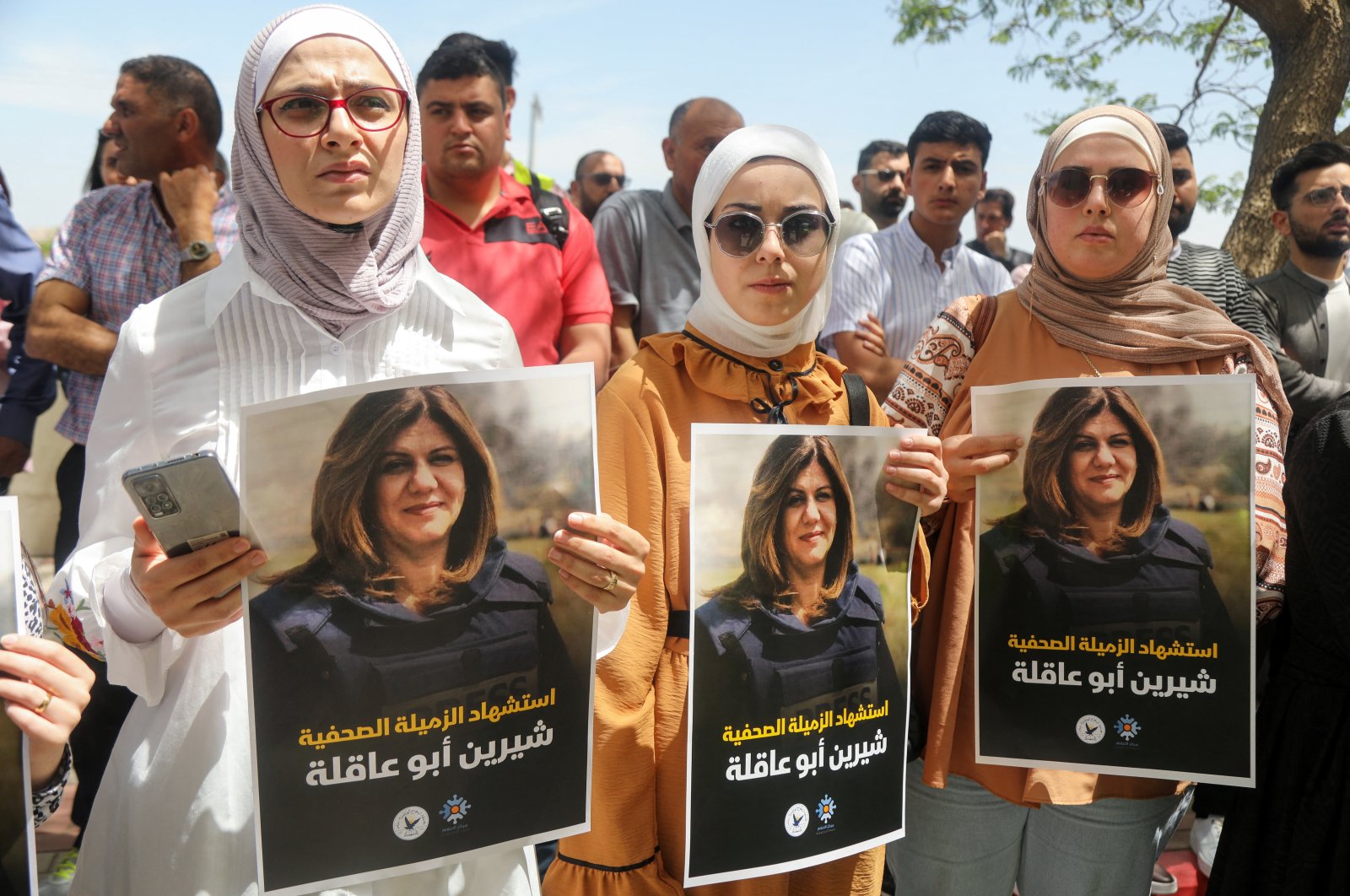 Palestinians hold pictures of Al-Jazeera reporter Shireen Abu Akleh, who was killed by Israeli army gunfire during an Israeli raid, in the occupied West Bank, Palestine, May 11, 2022. (Reuters Photo)