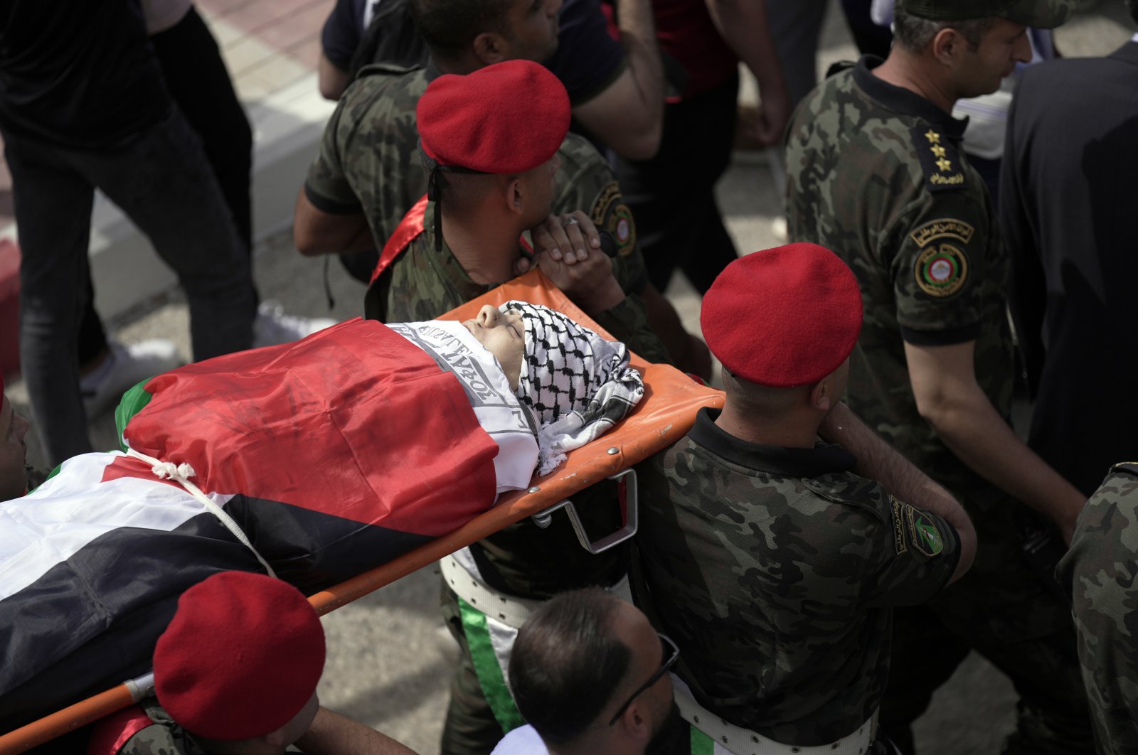 Slain Al-Jazeera veteran journalist Shireen Abu Akleh is carried by a Palestinian honor guard in the city of Nablus, the West Bank, Palestine, Wednesday, May 11, 2022. She was shot and killed while covering an Israeli raid in the occupied West Bank town of Jenin early Wednesday. (AP Photo/Majdi Mohammed)