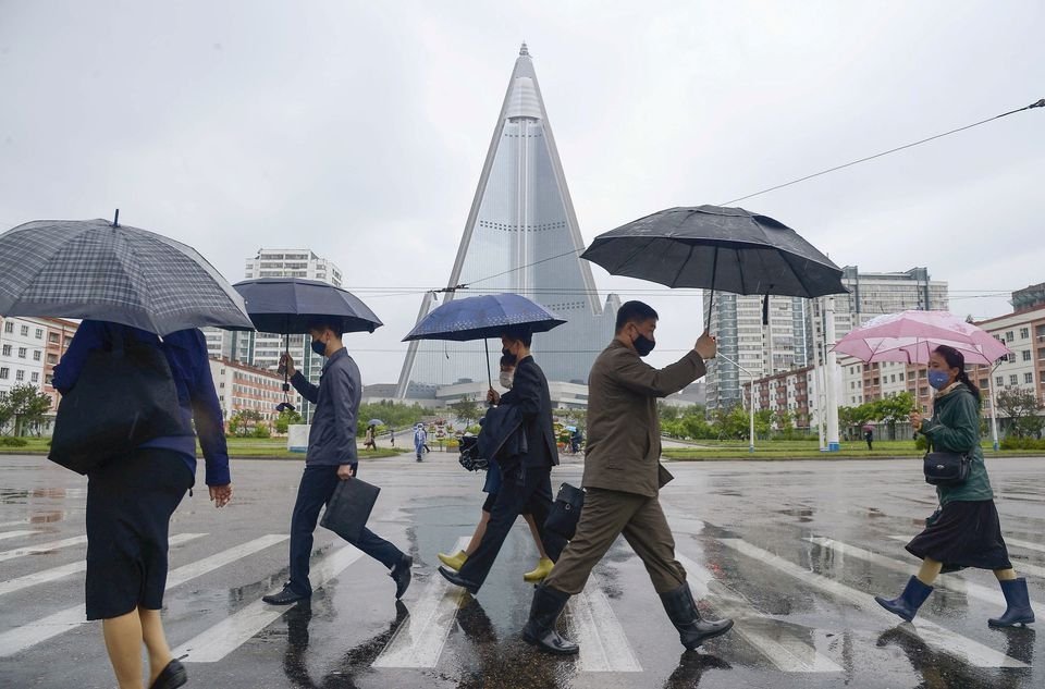 People wearing protective face masks walk amid concerns over the new coronavirus disease in Pyongyang, North Korea, May 15, 2020. (Reuters Photo)