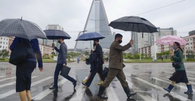 People wearing protective face masks walk amid concerns over the new coronavirus disease in Pyongyang, North Korea, May 15, 2020. (Reuters Photo)