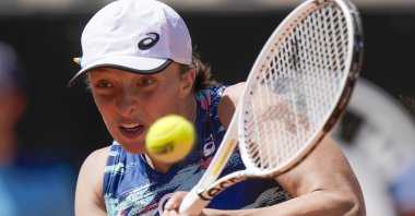 Iga Swiatek of Poland returns the ball to Victoria Azarenka of Belarus during their match at the Italian Open, Rome, Italy, May 12, 2022. (AP Photo)