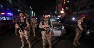  Pakistani security officials stand guard at the scene of an explosion in Karachi, Pakistan, May 12, 2022. (EPA Photo)