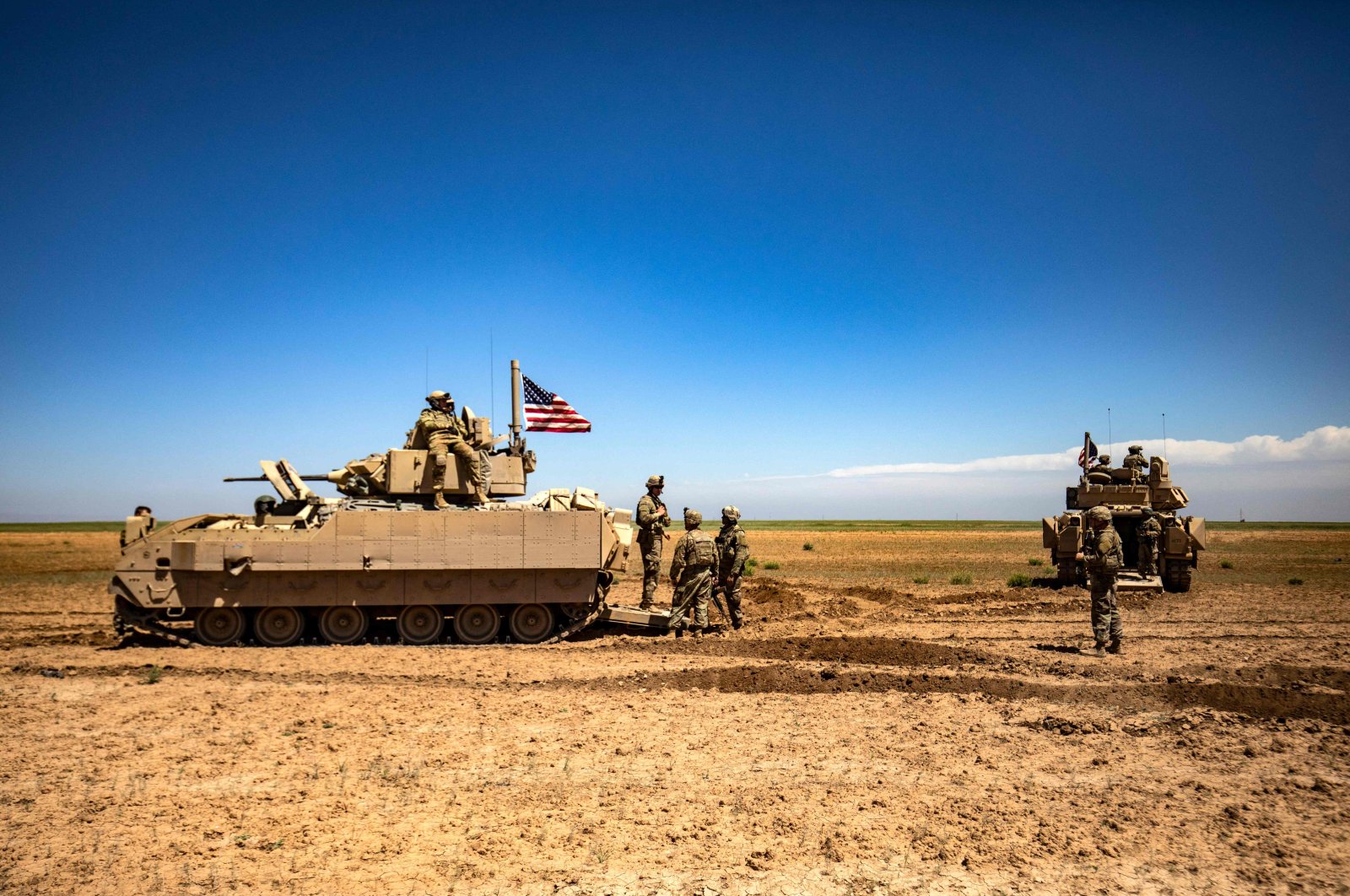 U.S. Bradley Fighting Vehicles (BFV) patrol the countryside of the city of Qamishli in Syria&#039;s northeastern Hasakeh province, April 20, 2022. (AFP Photo)