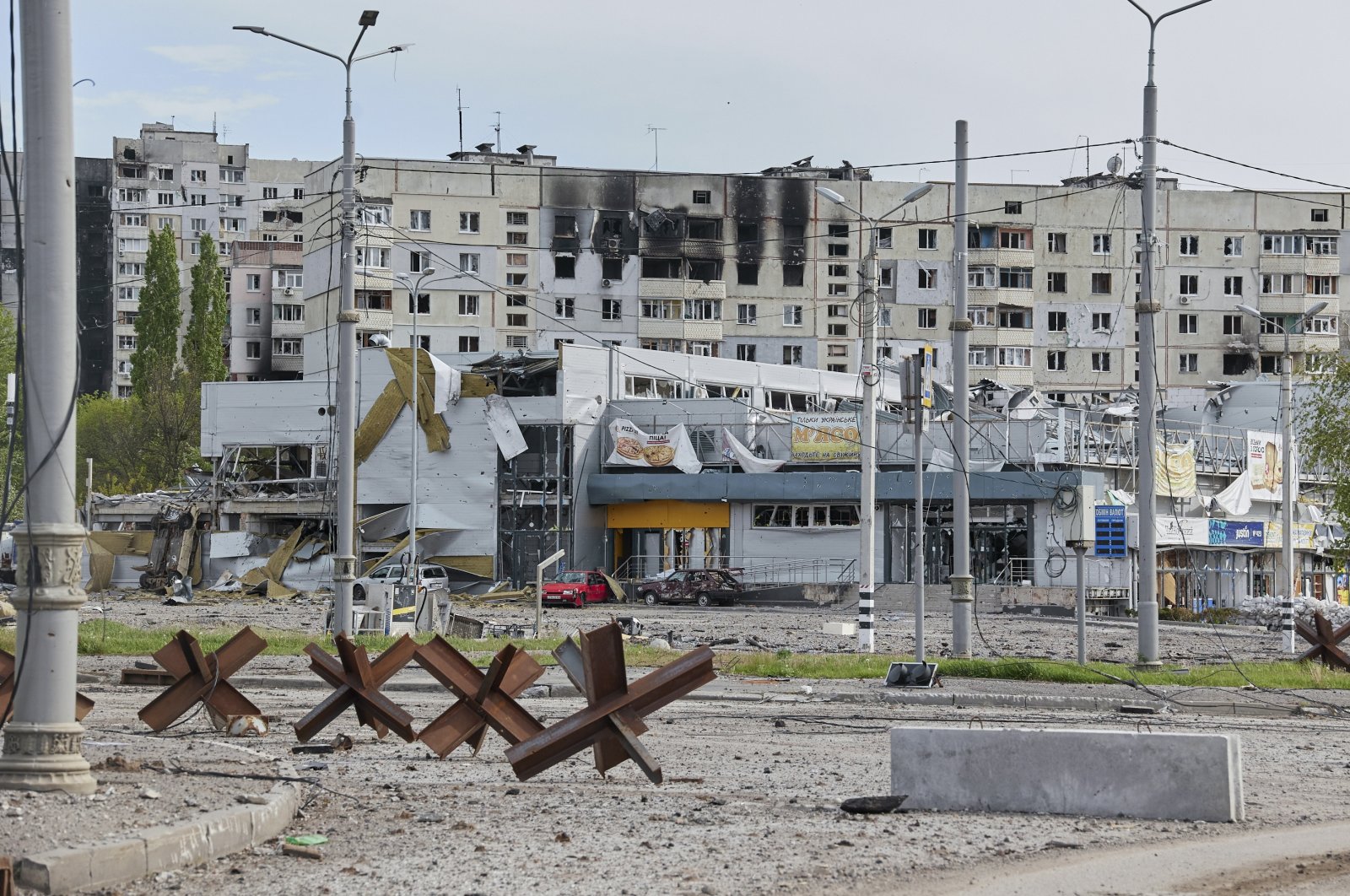 Damaged buildings at the North Saltovka region on the outskirts of Kharkiv, Ukraine, 11 May 2022. (EPA)