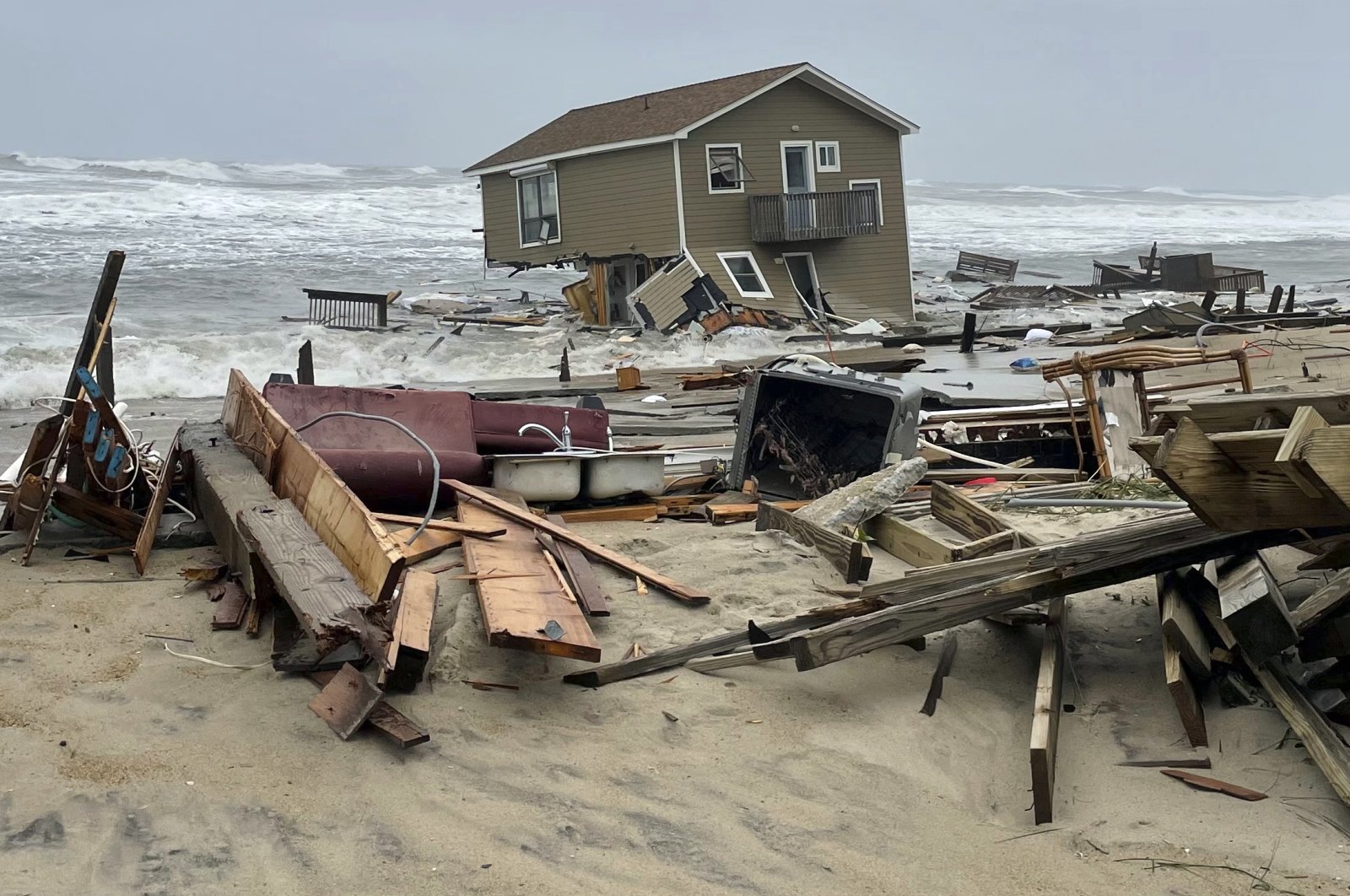 A beach house that collapsed along North Carolina&#039;s Outer Banks rests in the water, in Rodanthe, North Carolina, U.S., May 10, 2022. (National Park Service via AP)