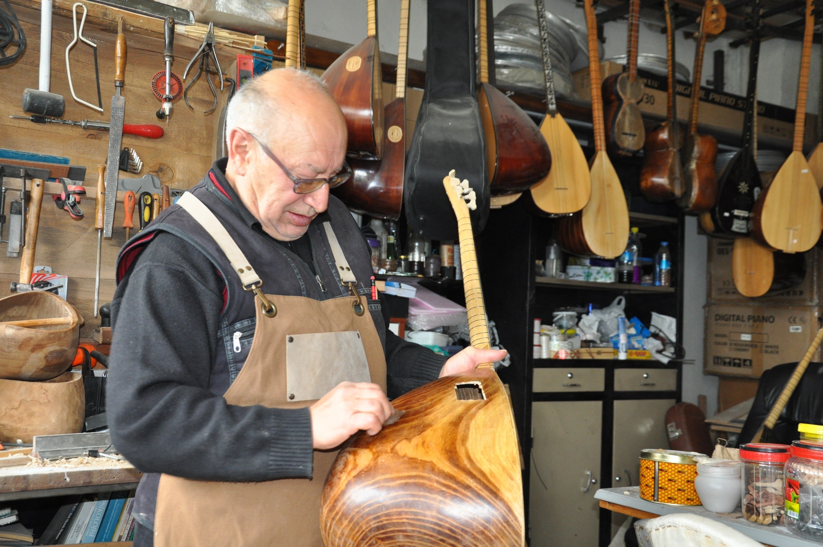 The 69-year-old Salih Şahin who continues his father&#039;s craft for 60 years, is making bağlama, Kars, Turkey, April 11, 2022. (IHA Photo)