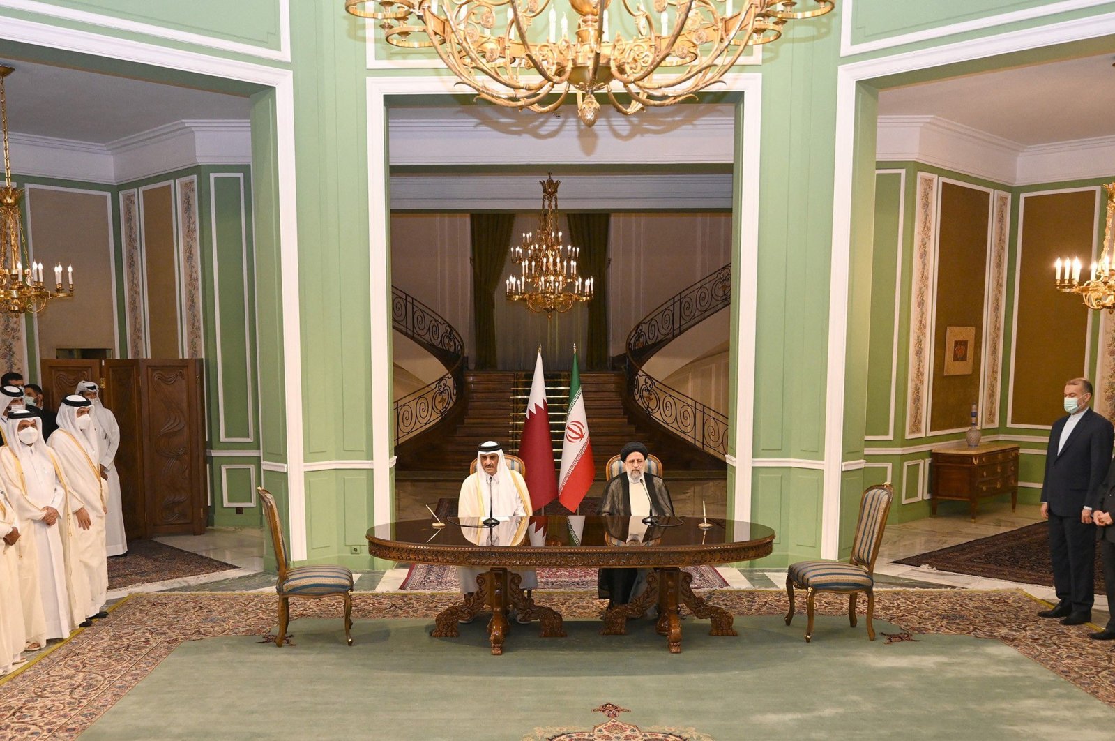 Qatar&#039;s Emir Sheikh Tamim bin Hamad Al Thani (C-L) meets with Iran&#039;s President Ebrahim Raisi, in the capital Tehran, May 12, 2022. (Photo by Qatar Amiri Diwan via AFP)