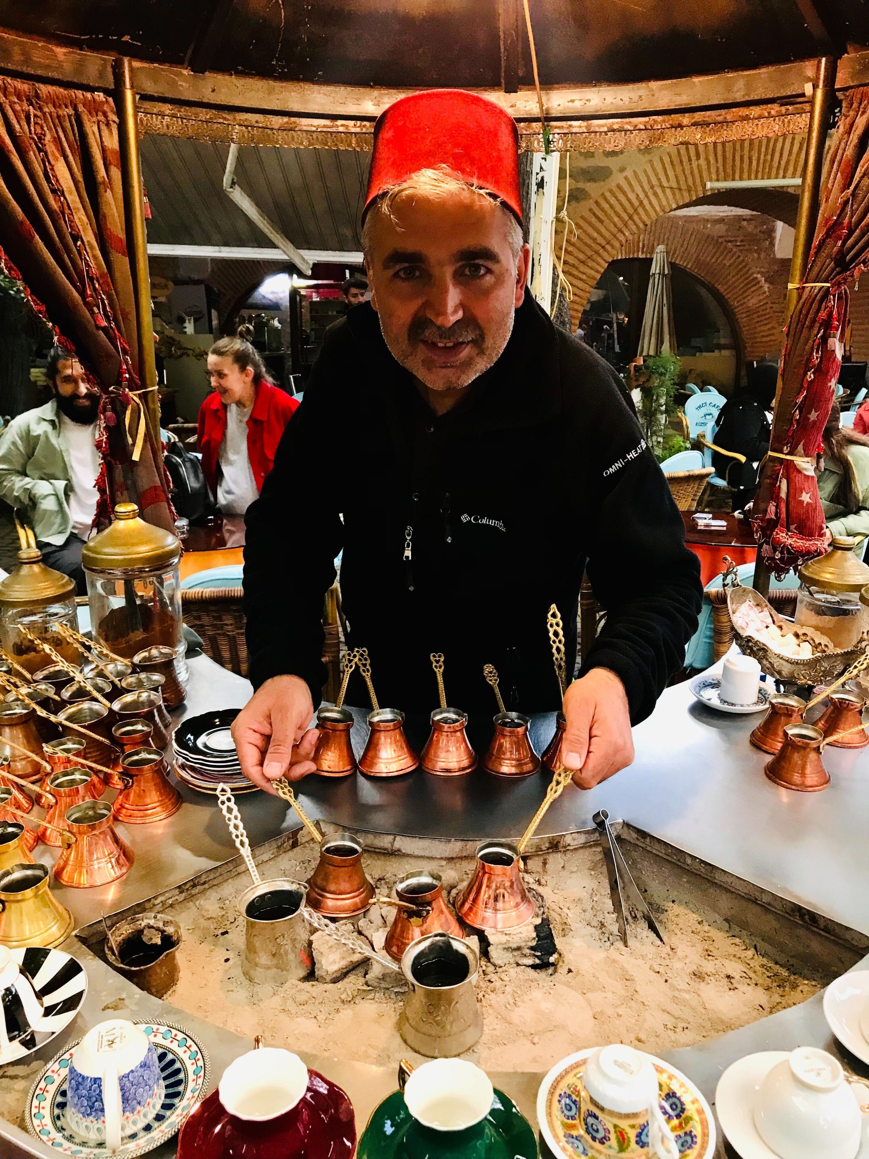 A Turkish coffee master brews coffee on embers in Koza Han, Bursa, Turkey, May 2, 2022. (Photo courtesy of Buse Keskin)