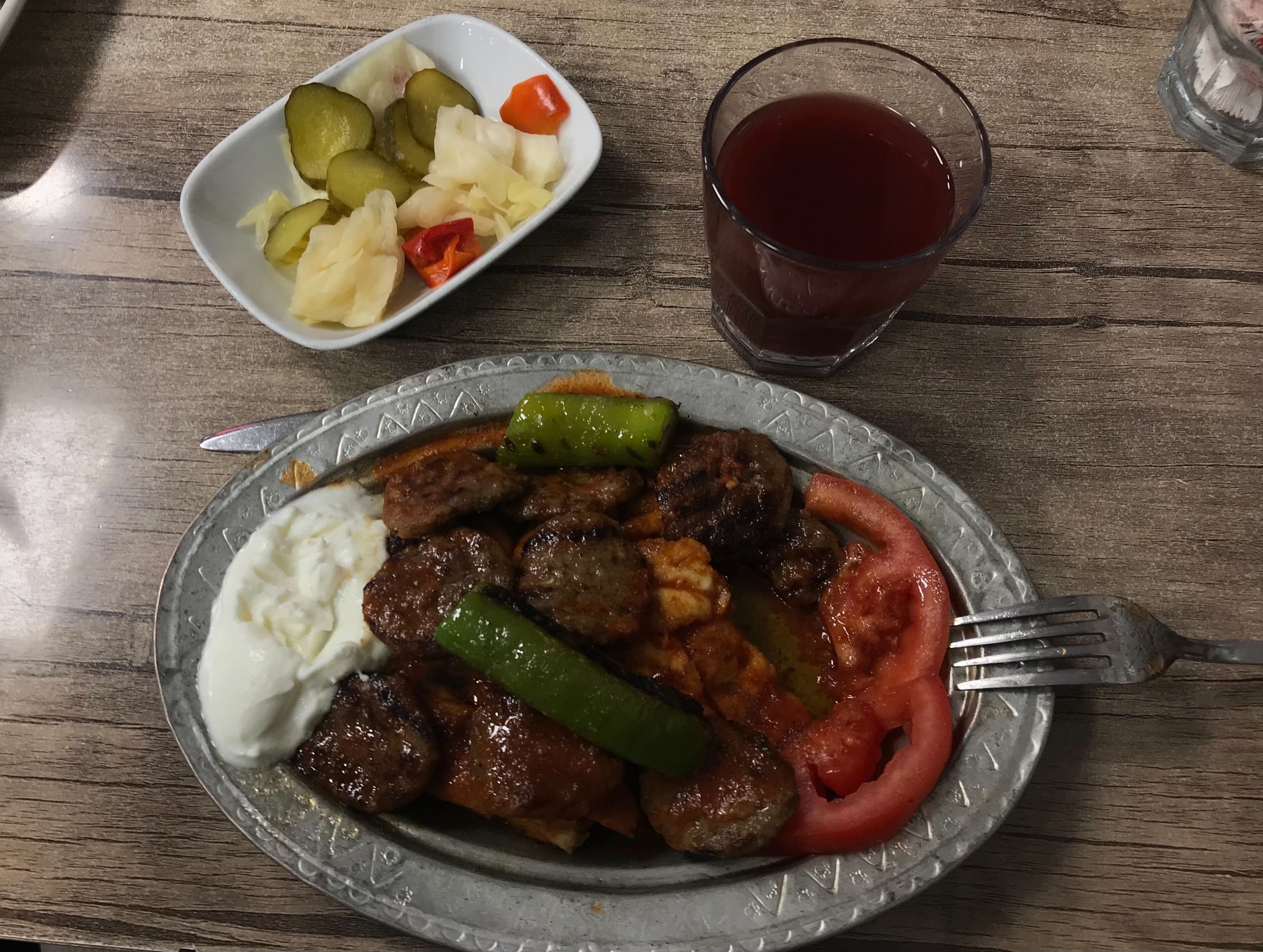 Pideli köfte accompanied by şıra (fermented grape juice) in Kayhan Bazaar, Bursa, Turkey, May 2, 2022. (Photo courtesy of Buse Keskin)