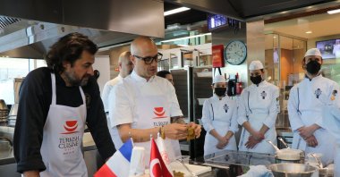 French journalists and influencers attending a workshop on making of stuffed grape leaves with sour cherries under the direction of Turkish chef Ali Ronay (R), Paris, France, May 11, 2022. (AA Photo)